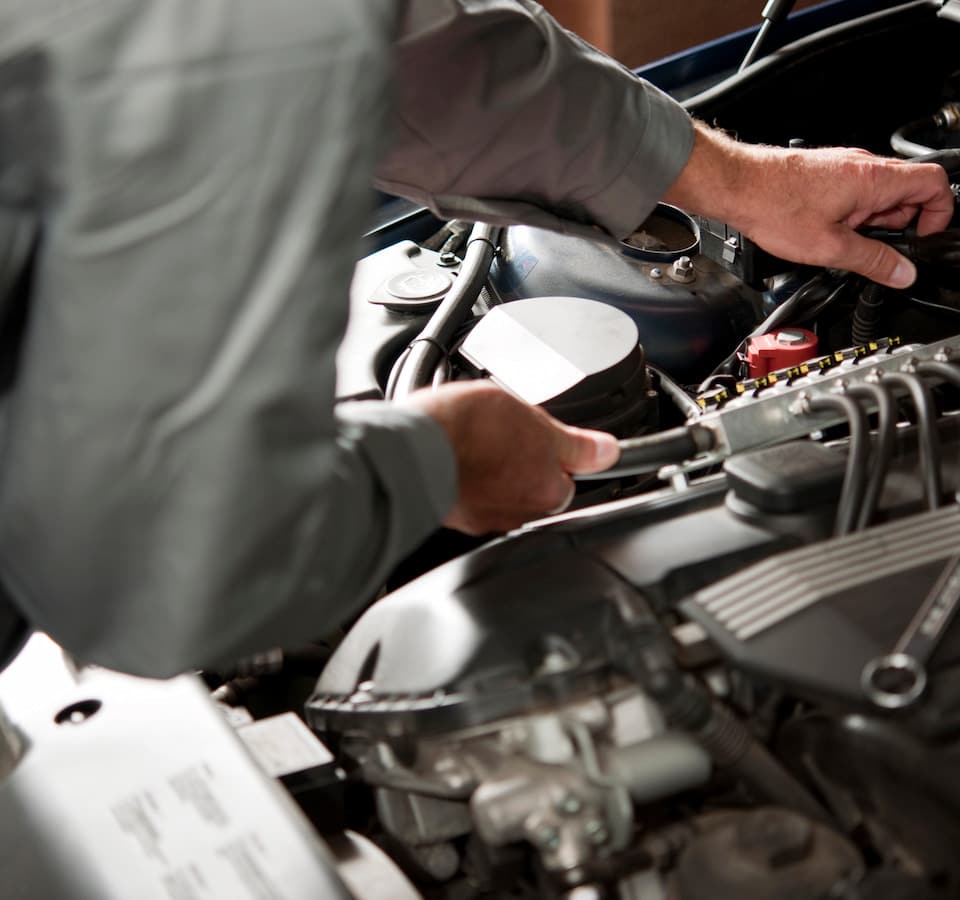 Auto Engine Repair Denver image Person repairing car engine under hood