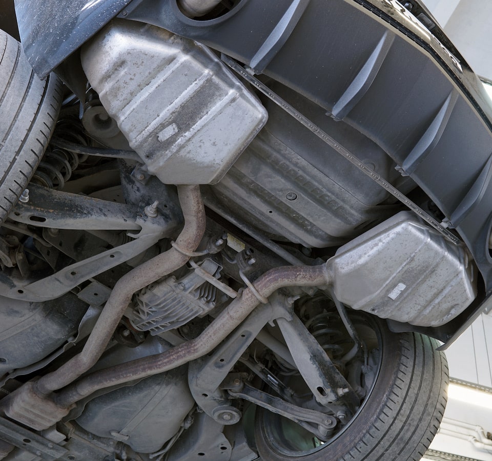 Auto Exhaust & Catalytic Converter Repair Denver image Car undercarriage showing exhaust and suspension components