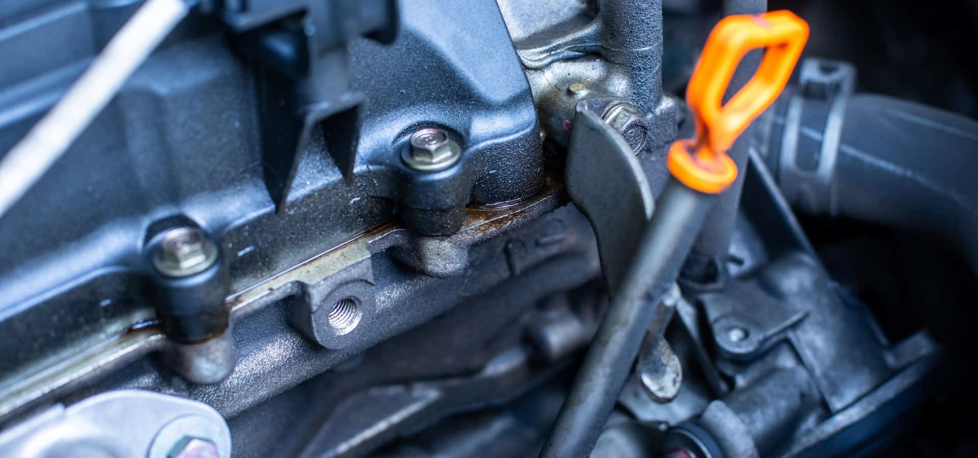 Close-up of car engine with oil dipstick