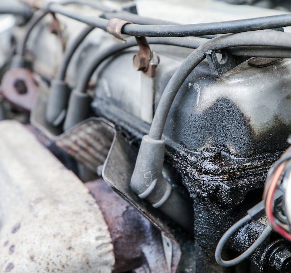 Auto Oil Leak Repair Denver image Close-up of car engine with oil leak
