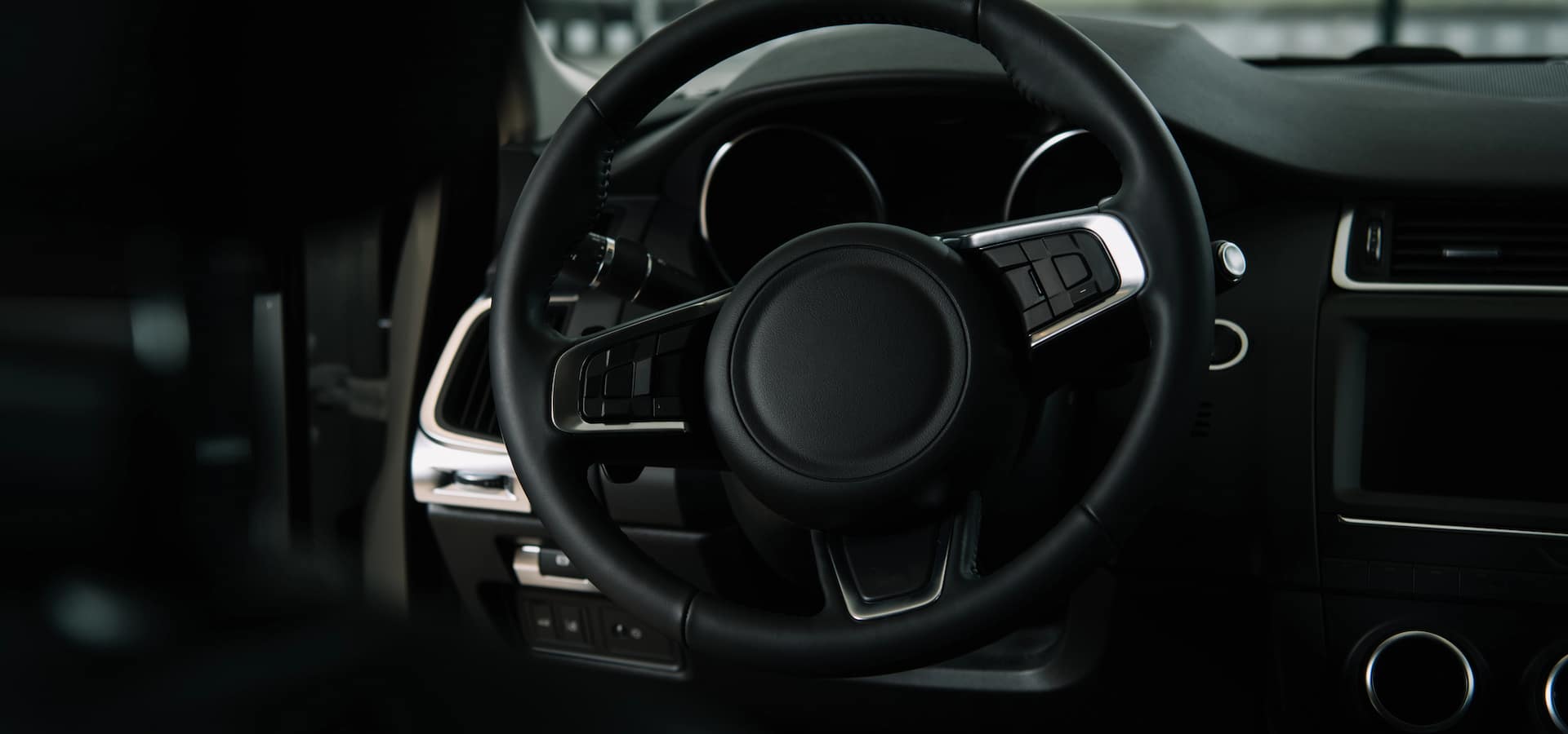 Close-up of modern car steering wheel and dashboard