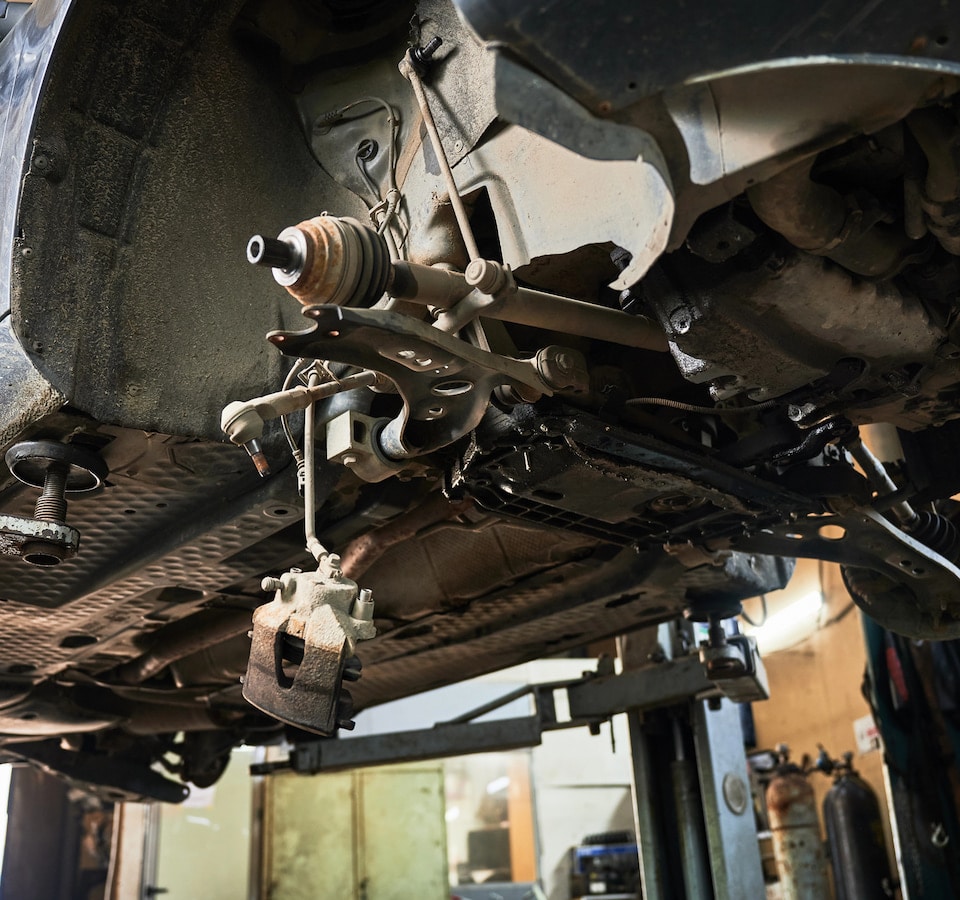 Auto Steering Repair Denver image Car suspension and brake assembly on lift