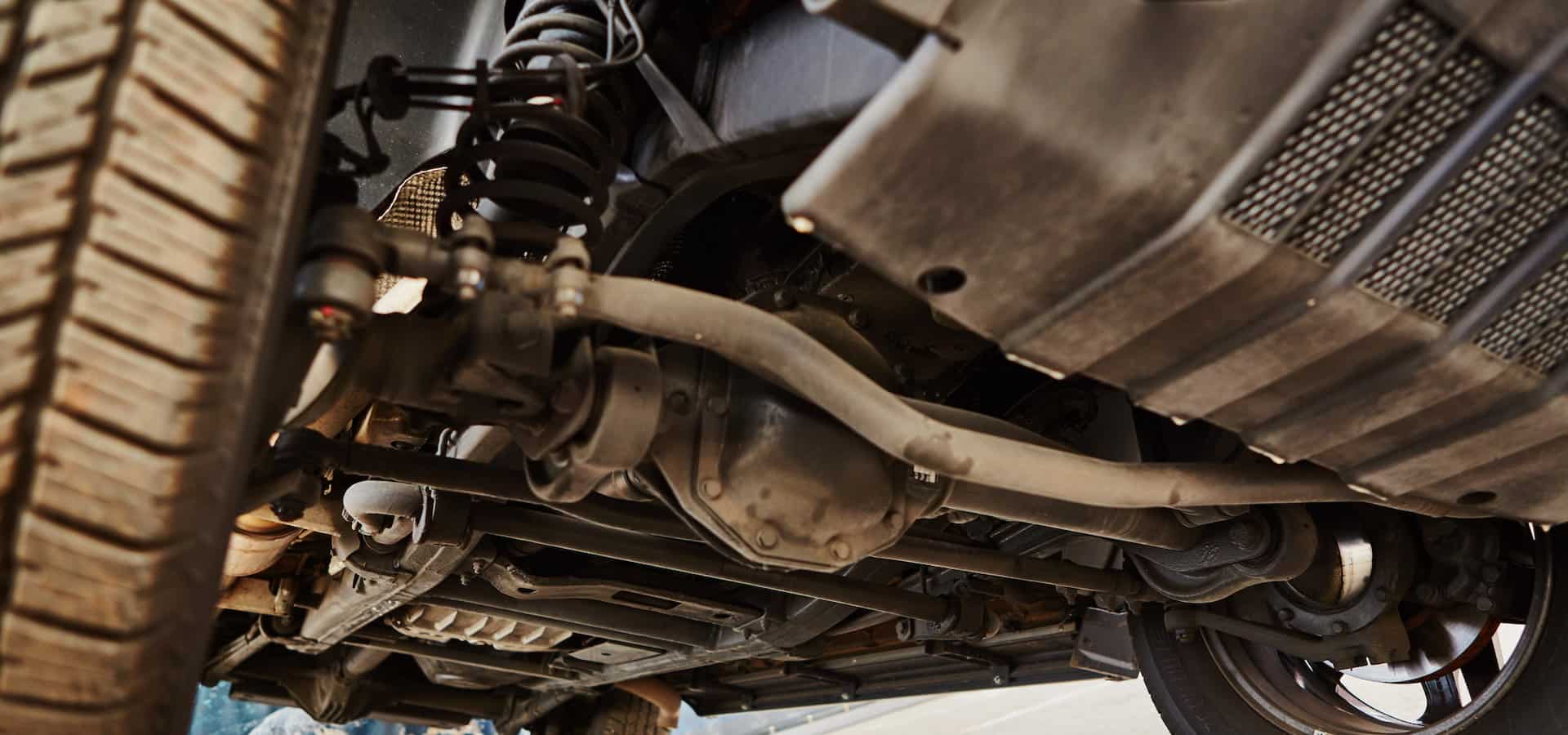 Undercarriage of vehicle showing suspension and exhaust system
