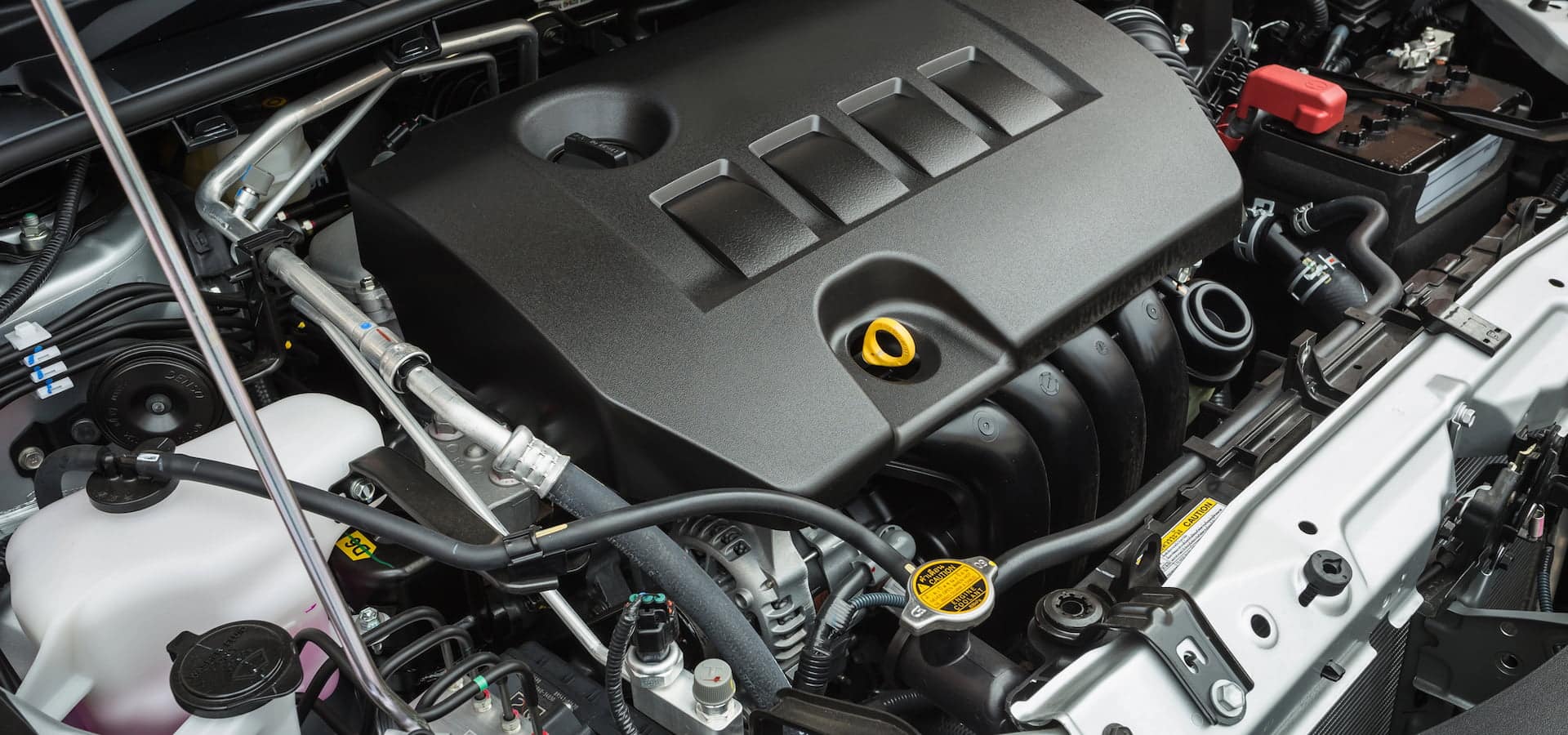 Modern car engine bay with plastic cover