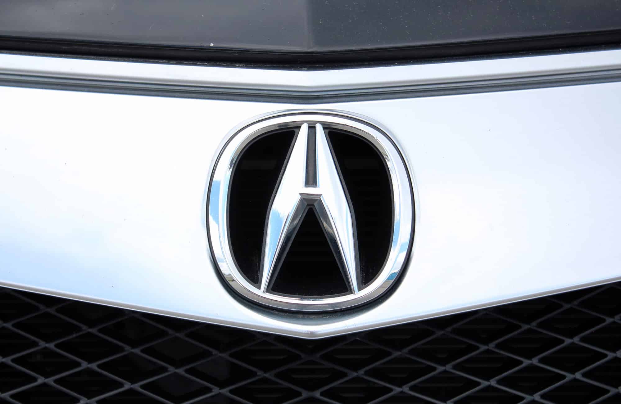 Acura logo on white car grille