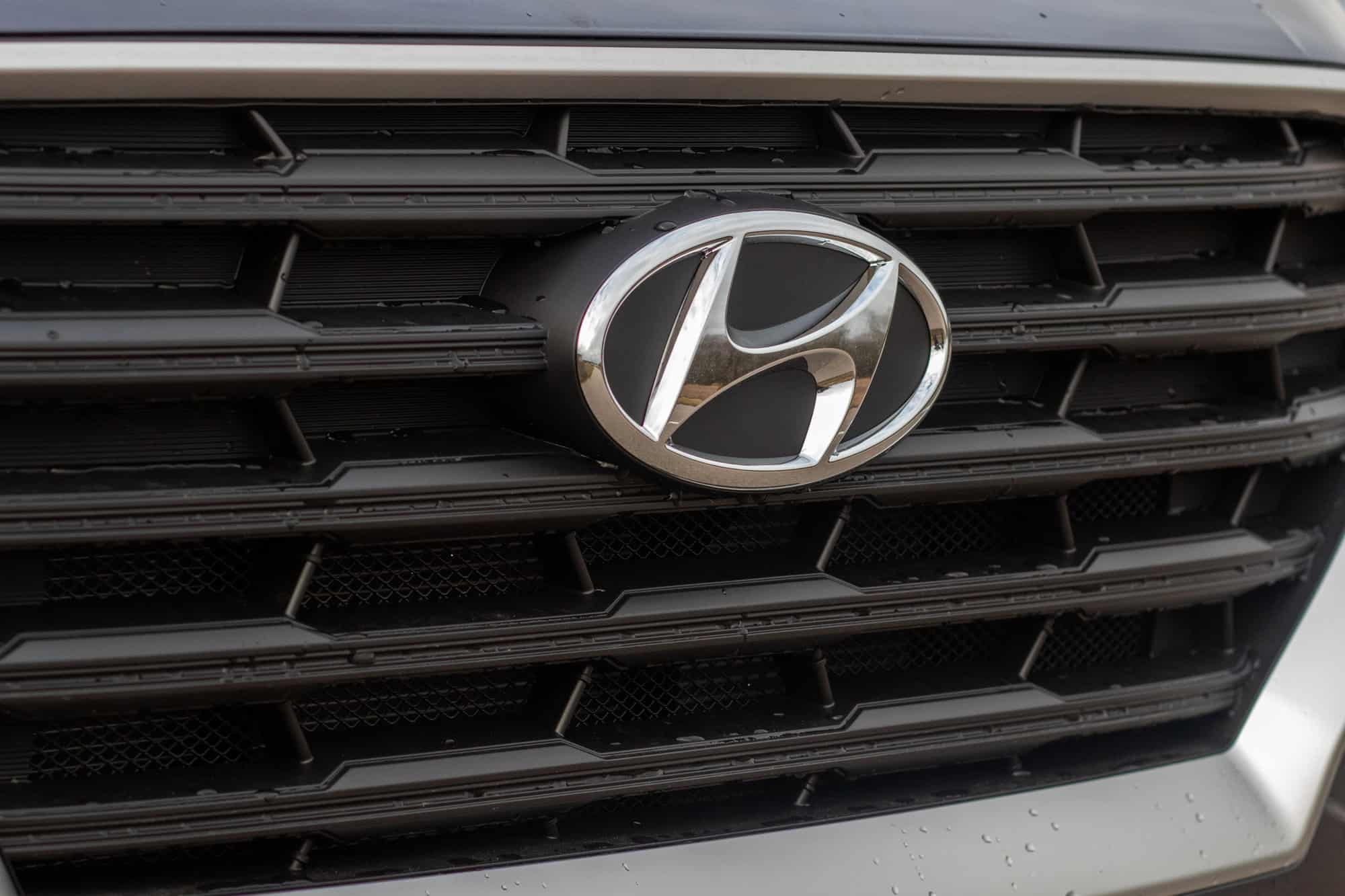 Hyundai emblem on black car grille