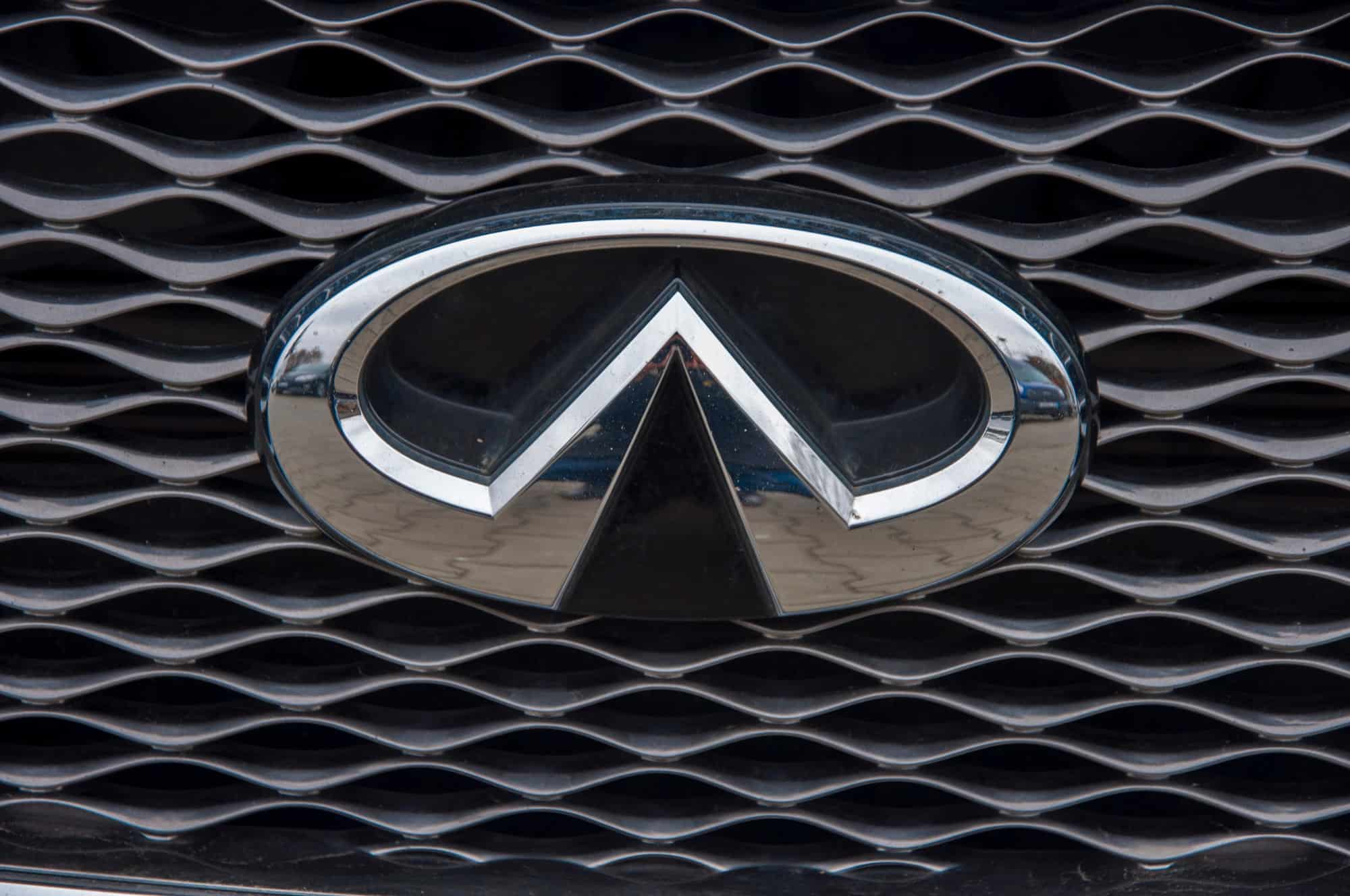 Infiniti car logo on black grille