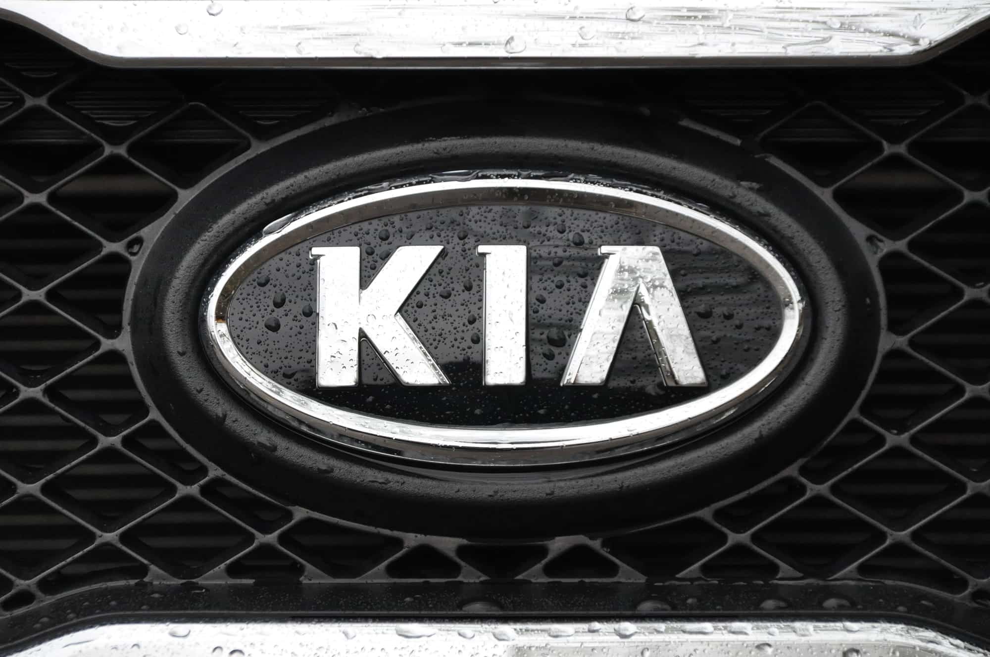 Kia logo on wet car grille