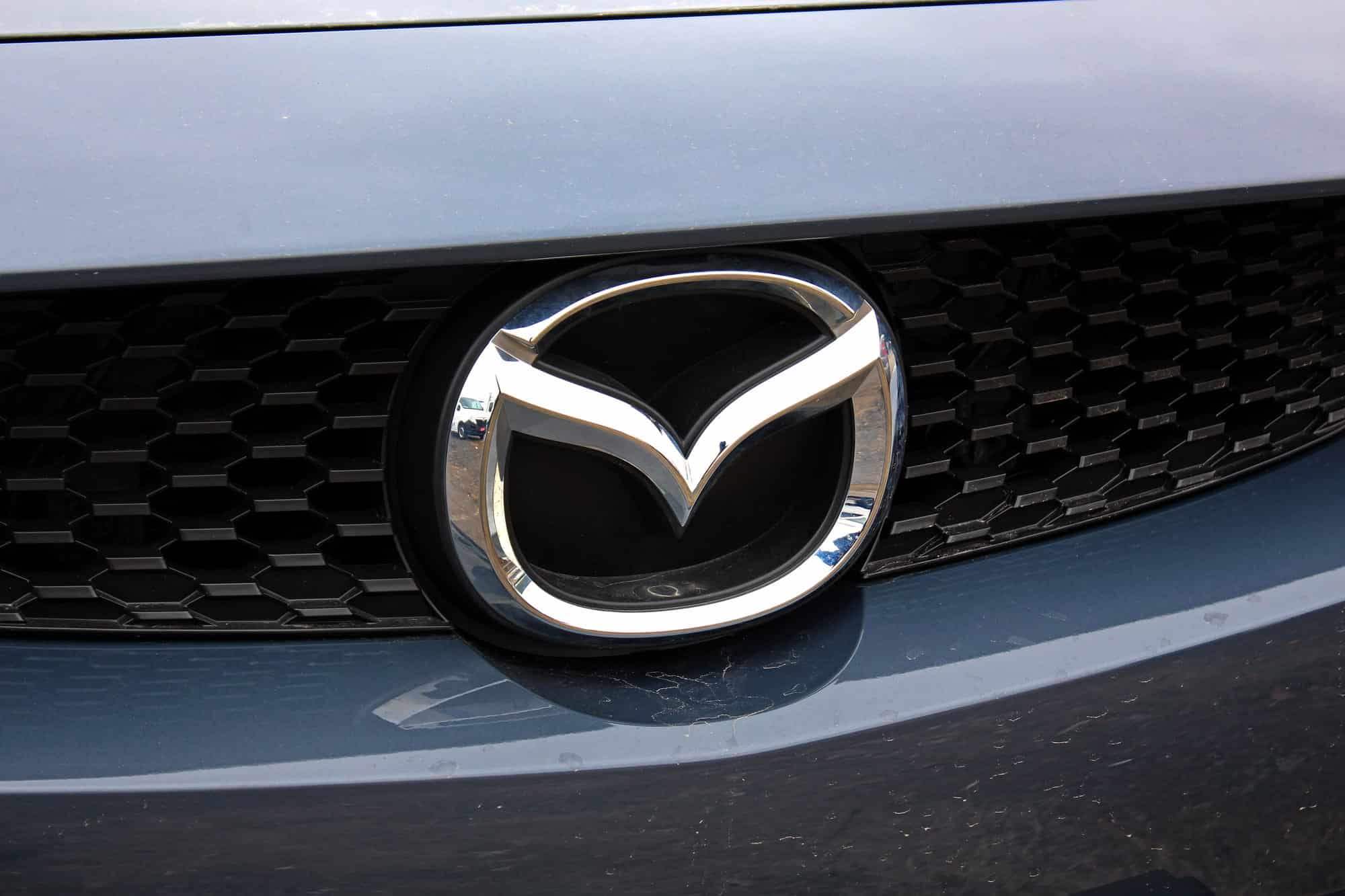 Mazda emblem on black car grille