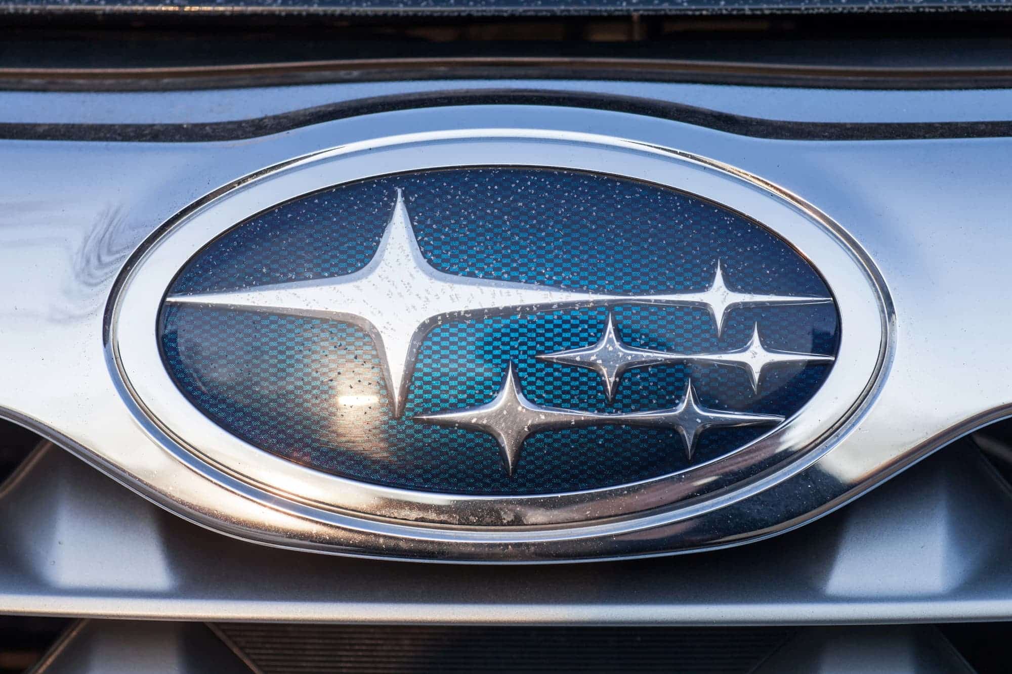 Subaru logo on car grille close-up