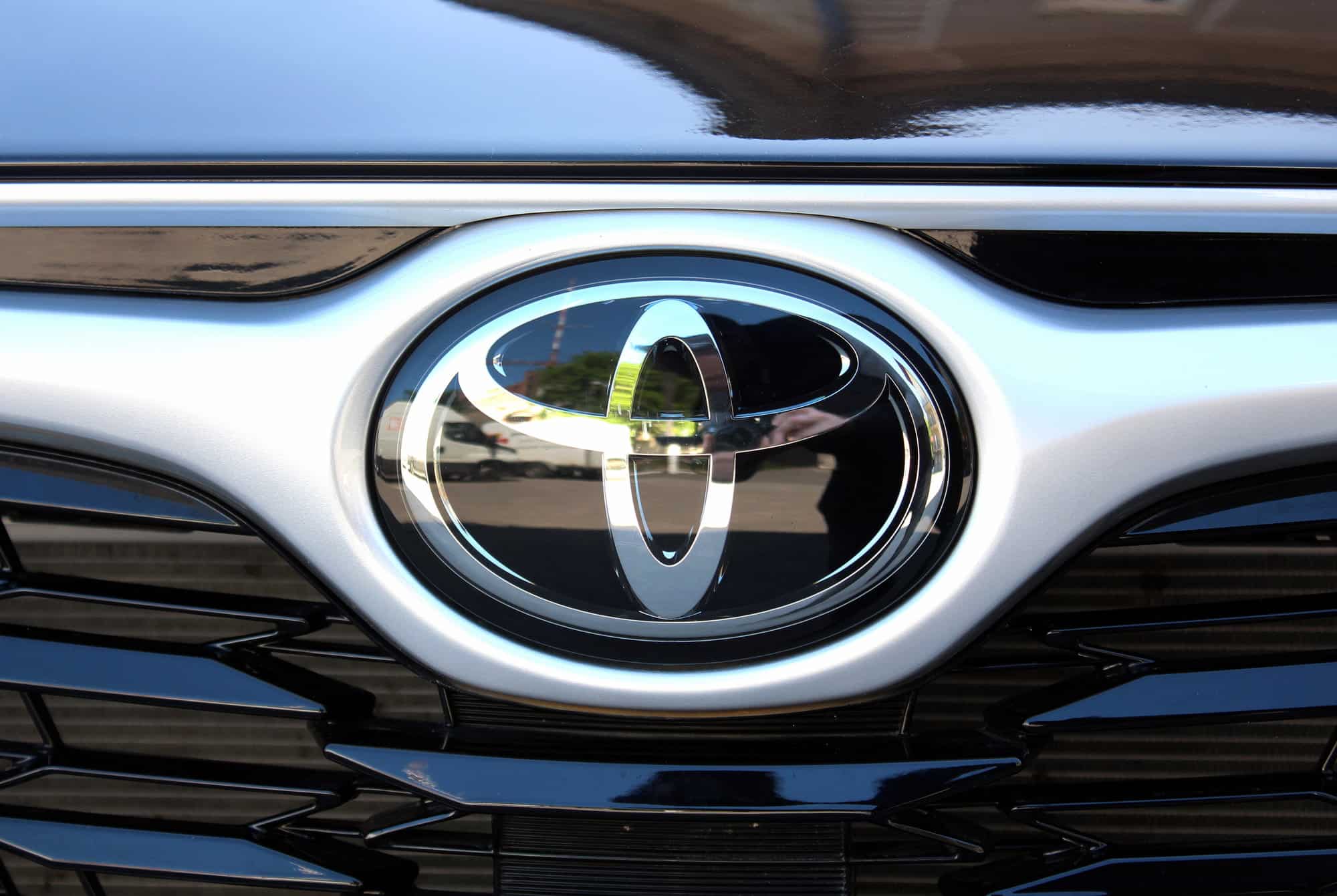 Close-up of Toyota emblem on car grille
